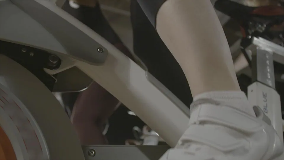 An image of a closeup of a someone's foot cycling on a stationery bike.