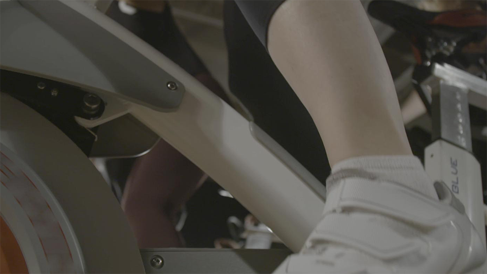 An image of a closeup of a someone's foot cycling on a stationery bike.