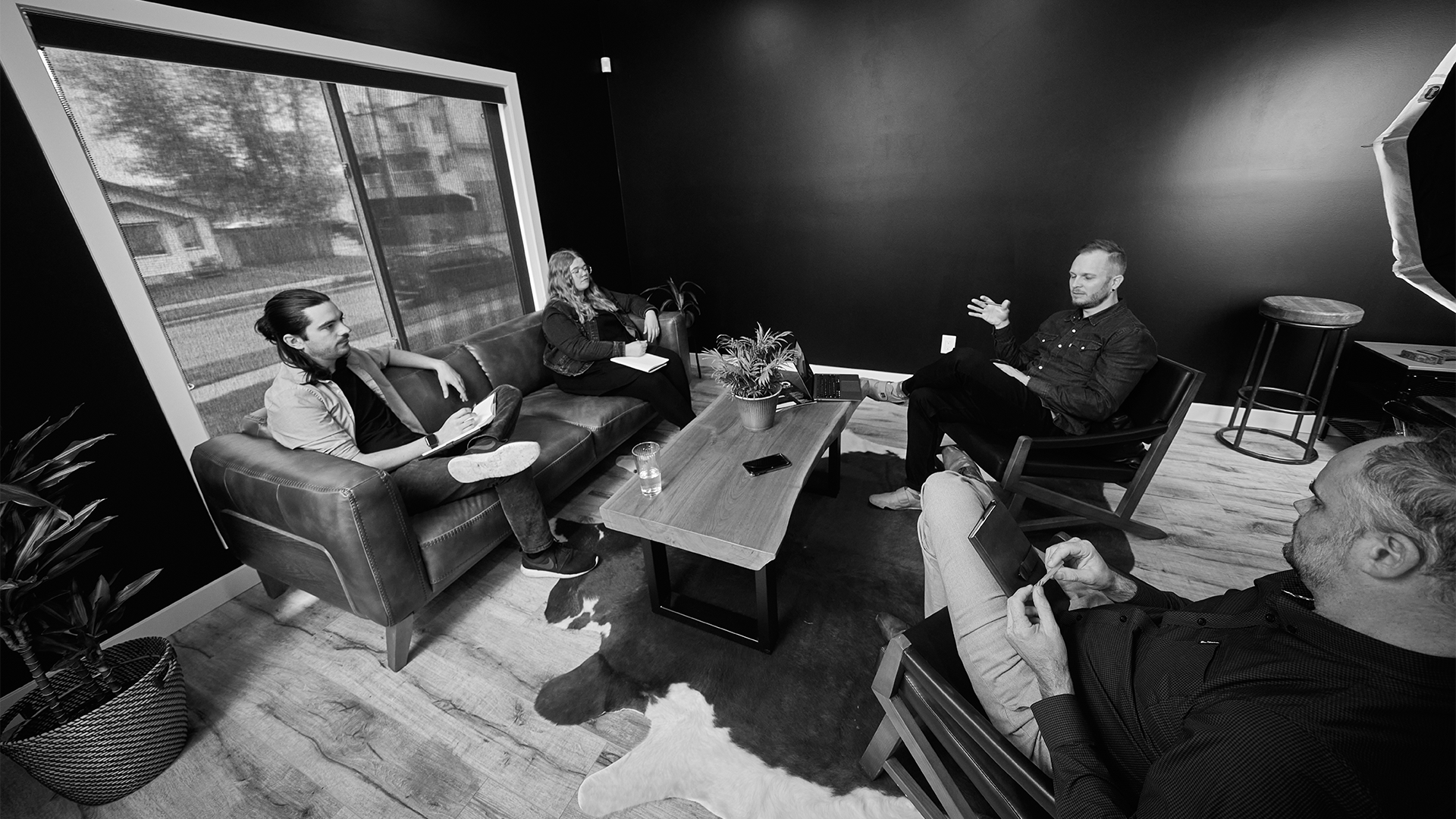 An image of the Coelement team meeting in a space with couches and a wooden coffee table.