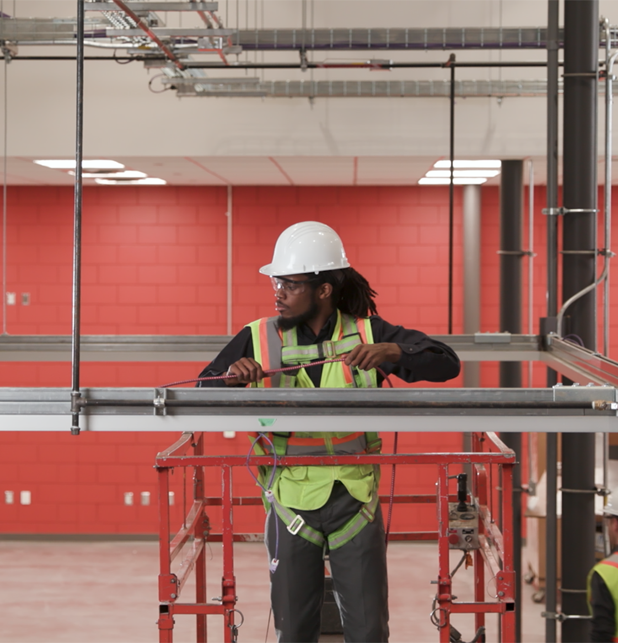 An image of an engineering student working on a lift.